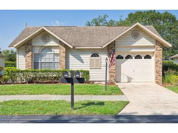 Charming single-story home featuring well-maintained landscaping, a one-car garage, and a welcoming facade at 4655 Wallingford Ct # 4655, New Port Richey, FL 34655