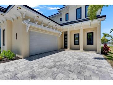 Beautiful home exterior featuring a spacious driveway and a modern design with architectural details at 6522 Simone Shores Cir, Apollo Beach, FL 33572