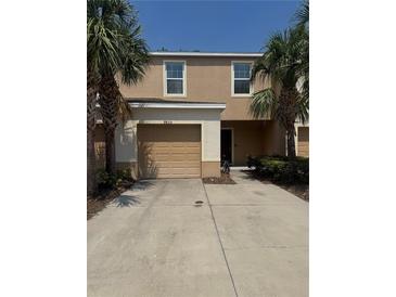 Charming townhouse featuring a one car garage and a well-maintained yard at 9833 Hound Chase Dr, Gibsonton, FL 33534