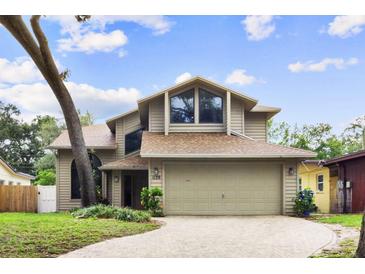 Charming tan two-story home with large windows and well-maintained landscaping for great curb appeal at 1139 43Rd N Ave, St Petersburg, FL 33703