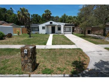 Charming single-story home with a well-maintained front yard and a neatly paved walkway leading to the entrance at 1762 Fulton Ave, Clearwater, FL 33755