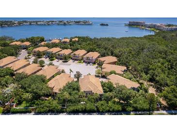 Stunning aerial view of waterfront homes surrounded by lush greenery with boat docks and scenic water views at 191 Banyan Bay Dr, St Petersburg, FL 33705