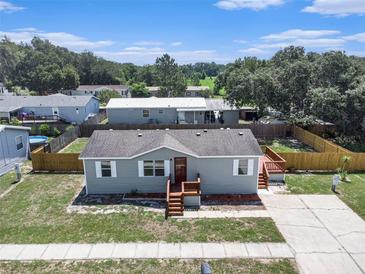 Charming home featuring a gray exterior, complemented by stylish wooden decks and steps at 3924 Kiah Dr, Wesley Chapel, FL 33543