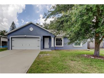 Charming one-story home featuring a spacious yard and attached two-car garage at 6145 103Rd N Ave, Pinellas Park, FL 33782