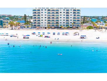 Aerial view of the beach featuring white sand and turquoise water at this beachside condo complex at 13500 Gulf Blvd # 506, Madeira Beach, FL 33708