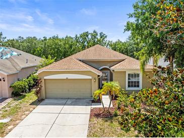 Charming single-story home features a well-manicured lawn, lovely landscaping, and an attached two-car garage at 1611 Cresson Ridge Ln, Brandon, FL 33510