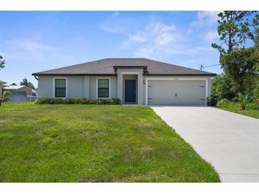 Charming single-story home with a well-manicured lawn and a neutral-colored facade at 4831 Hillman Ter, North Port, FL 34288