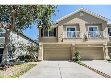 Inviting two-story townhouse with a two-car garage and dual balconies at 6736 Breezy Palm Dr, Riverview, FL 33578