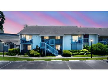 Two-story condo building with a blue stairwell and balcony in a well-maintained community at 11201 122Nd Ave # 167, Largo, FL 33778
