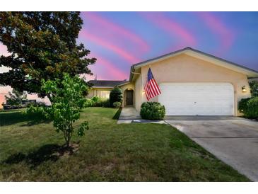 Charming single-story home with a manicured lawn and an attached two-car garage at 11746 93Rd Ave, Seminole, FL 33772