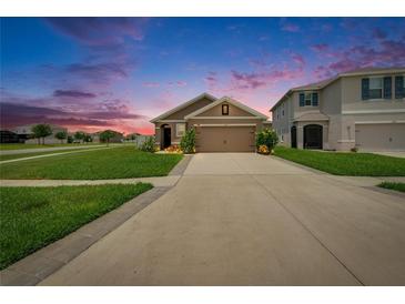 Charming one-story home with a well-maintained lawn and a spacious driveway, perfect for suburban living at 1398 Crescent Hoop Way, Wesley Chapel, FL 33543