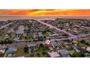 Beautiful waterfront home with a large lot, boat dock, and stunning sunset views over the water at 4299 Bellaire Dr, Hernando Beach, FL 34607
