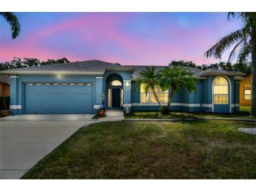 Charming single-story blue home with manicured lawn and well-maintained landscaping at 4612 35Th E Ave, Palmetto, FL 34221