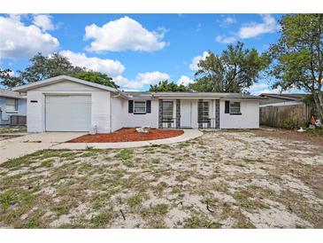 Charming single-story home featuring a front yard and attached garage at 11130 White Oak Ln, Port Richey, FL 34668