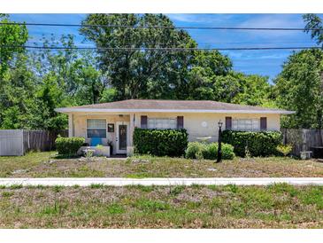 Charming single-story home featuring a well-maintained front yard and a welcoming facade at 1683 Pine St, Largo, FL 33774