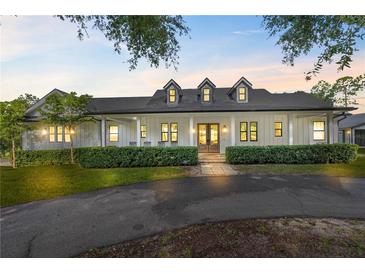 Well-maintained home with manicured front lawn and inviting covered porch at 18577 Clay Hill Rd, Dade City, FL 33523