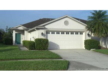 Charming single-story home featuring a two-car garage, manicured lawn, and well-maintained landscaping at 1922 Sassafras Dr, Wesley Chapel, FL 33543