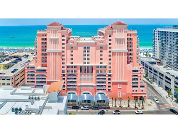 Stunning view of the pink beachfront condo with balconies and ocean view at 301 S Gulfview Blvd # 301, Clearwater Beach, FL 33767