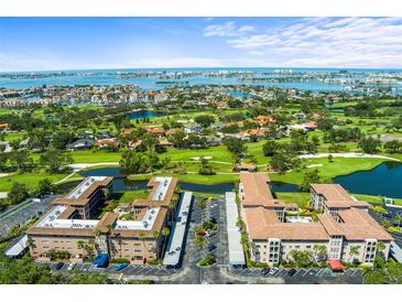 Stunning aerial view of condos overlooking a golf course, lakes, and the ocean at 6100 Gulfport S Blvd # 114, Gulfport, FL 33707