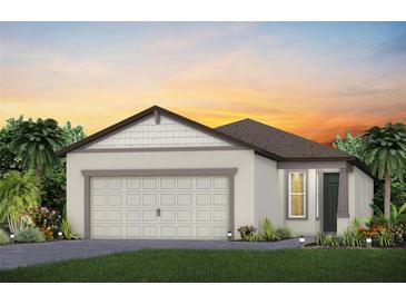 Charming single-story home featuring a two-car garage and beautifully landscaped front yard at 9542 Coastline Way, Parrish, FL 34219
