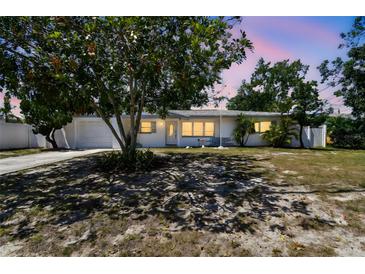 Charming single-story home with a well-maintained front yard and a mature tree in the yard at 11735 86Th Ave, Seminole, FL 33772