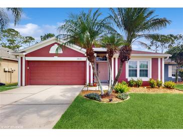 Charming single-Gathering home featuring a well-maintained lawn and beautiful palm tree landscaping at 19635 Bellehurst Loop, Land O Lakes, FL 34638