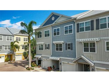 Charming townhome featuring a colorful exterior and beautiful architectural design at 3138 Nautical S Pl, St Petersburg, FL 33712