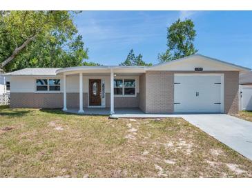 Charming single Gathering home featuring a decorative front door, garage, and inviting curb appeal at 6309 7Th Ave, New Port Richey, FL 34653