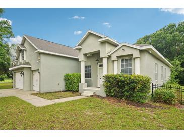 Charming home with a well-maintained lawn, attached two car garage, and an inviting front entrance at 707 9Th Sw Ave, Ruskin, FL 33570