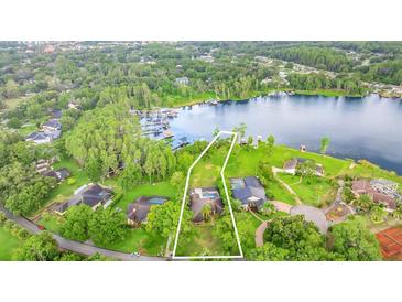 Exceptional lakefront home with a private pool surrounded by lush landscaping at 707 Warren Rd, Lutz, FL 33548