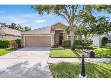 Charming single Gathering home features a well-manicured lawn, lovely landscaping, and two car garage at 11324 Cypress Reserve Dr, Tampa, FL 33626