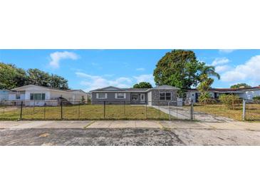 Charming single-story home with fenced front yard and a mix of stone and siding accents at 11809 129Th Ave, Largo, FL 33778