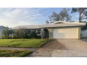 Charming single-story home with a well-manicured lawn and a two-car garage at 13000 90Th Ave, Seminole, FL 33776