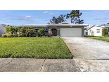 Charming single-story home with a well-manicured lawn and an attached two-car garage at 13000 90Th Ave, Seminole, FL 33776