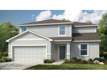 Charming two-story home with attached two car garage, neatly manicured lawn, and welcoming entryway at 13576 Tropical Breeze Way, Hudson, FL 34669