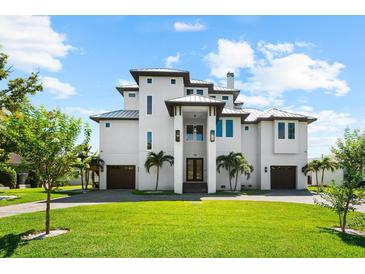 Stunning multi-story modern home featuring manicured lawn and two-car garage in a desirable neighborhood at 110 Carlyle Dr, Palm Harbor, FL 34683