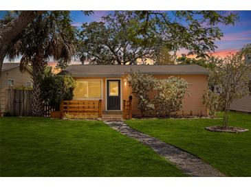 Charming single-story home featuring a stone pathway, manicured lawn, and inviting front porch at 131 44Th N Ave, St Petersburg, FL 33703