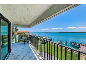 Enjoy beautiful waterfront views from this spacious balcony with outdoor seating area at 240 Sand Key Estates Dr # 222, Clearwater, FL 33767