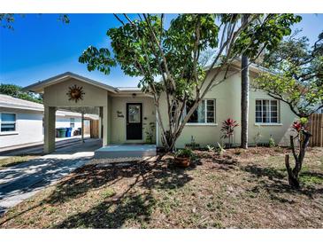 Charming single-story home with a covered carport, well-maintained landscaping, and a walkway to the front door at 420 Roanoke St, Dunedin, FL 34698