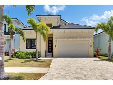 Inviting single-Gathering home features a manicured lawn, tropical landscaping, and a spacious two-car garage at 6532 Simone Shores Cir, Apollo Beach, FL 33572