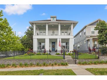 Stunning two-story home featuring dual covered balconies, a well-manicured lawn, and a charming gated yard at 702 34Th N Ave, St Petersburg, FL 33704