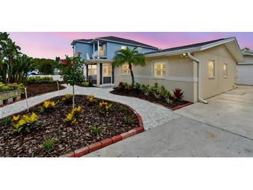 Charming home featuring attractive landscaping, a well-maintained lawn, and a welcoming facade at 807 Illinois Ave, Palm Harbor, FL 34683