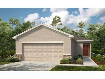 Charming single-Gathering home with a two-car garage, well-manicured lawn, and beautiful front door at 12435 Gust Ct, Hudson, FL 34669