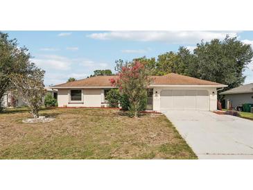 Charming single-story home with an attached two-car garage and well-maintained landscaping at 1521 Fireside St, Port Charlotte, FL 33952