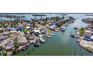 Waterfront home with multiple docks and boat lifts provides direct access to the Gulf of Mexico at 253 Boca Ciega Dr, Madeira Beach, FL 33708