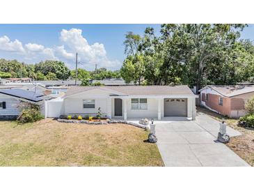 Charming single-story home with well-maintained front yard, attached garage, and inviting curb appeal at 3445 Pinehurst Dr, Holiday, FL 34691