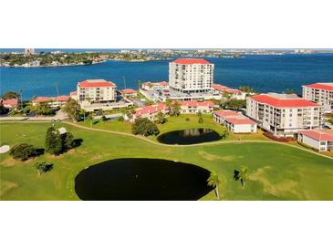 A captivating aerial view of the condo community, showcasing lush lawns, serene ponds, and stunning waterfront vistas at 6265 Sun Blvd # 605, St Petersburg, FL 33715