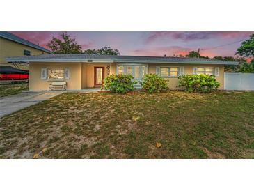 Charming single-story home featuring a well-maintained lawn and inviting entrance with updated windows at 1412 Coburn Dr, Tarpon Springs, FL 34689