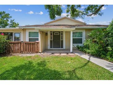 Inviting home entrance with well-maintained lawn and neutral exterior, providing a warm welcome at 15202 Morning Dr, Lutz, FL 33559