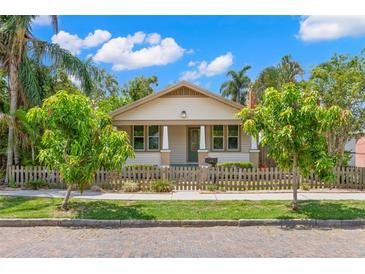 Charming single-story home featuring a manicured front yard and a quaint picket fence at 1530 21St N Ave, St Petersburg, FL 33704